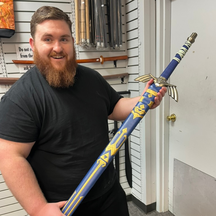 Photo of Easton J. Thomson holding a replica of the Master Sword from the Legend of Zelda